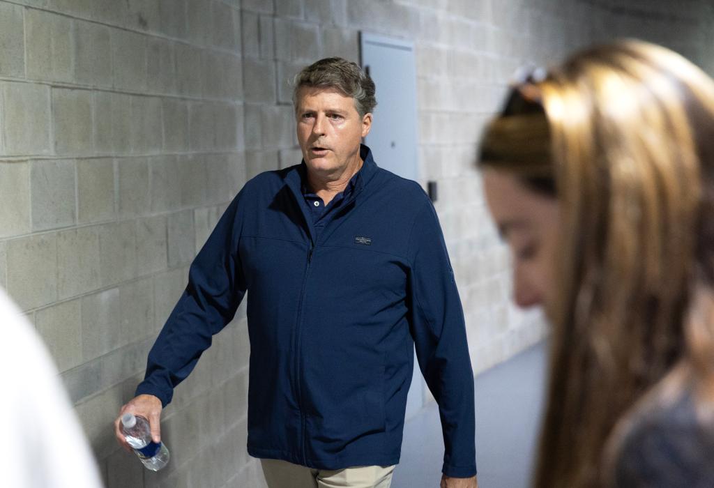 Hal Steinbrenner, co-owner of the New York Yankees, walking to a press conference at Steinbrenner Field in Tampa Florida, holding a water bottle