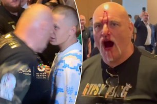 Tyson Fury's dad John headbutts a member of Oleksandr Usyk's team during media day on Monday. 