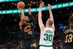 Donovan Mitchell, who scored a game-high 29 points, shoots a jumper over Sam Hauser during the Cavaliers' 118-94 Game 2 win over the Celtics.