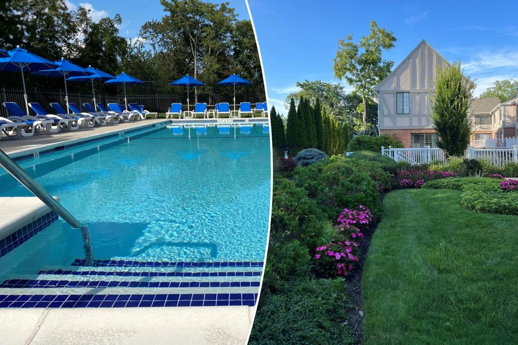 A pool and lawn area decorated with chairs and umbrellas