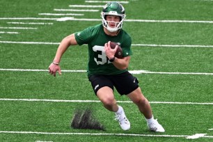 Isaiah Davis runs a drill during Jets' rookie minicamp on Friday.