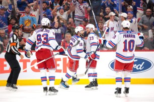 Rangers greets Vincent Trocheck #16 of the New York Rangers after Trocheck scores a goal on a power play during the first period.