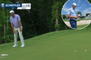 Scottie Scheffler tosses putter