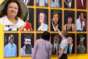 Gina Rinehart among a group of people looking at a wall with paintings