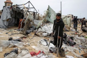 An injured Palestinian man inspecting the tent camp that was hit by an Israeli strike in Rafah on May 28, 2024.