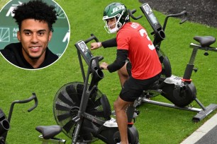 Jets quarterback Jordan Travis (above and inset) works out on the exercise bike to rehab the broken leg he suffered at Florida State in November.