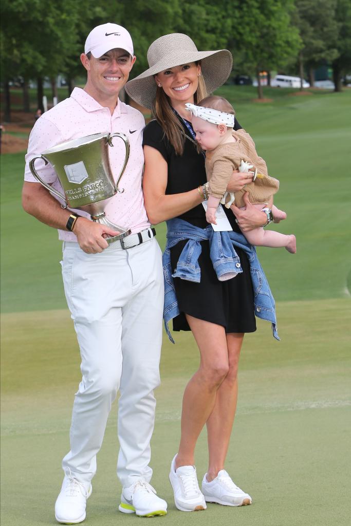 Rory McIlroy (NIR) displays the winner's trophy with his wife Erica and baby daughter Poppy on the 18th green after the final round of the Wells Fargo Championship on May 09, 2021, at Quail Hollow Club in Charlotte, NC. 