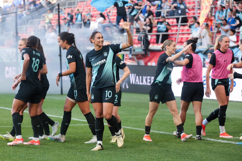 Lynn Williams (10) waves to the fans after scoring a record-setting goal in the second half against Chicago Red Stars at Red Bull Arena.
