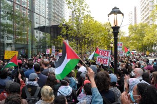 Pro-Palestine demonstrators rally, waving the Palestinian flag outside of the John A. Paulson Center at New York University.