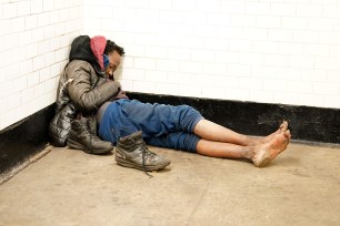 A general view of an apparently homeless person sleeping in a subway station at the 168th Street subway stop in New York, NY on April 11, 2024.