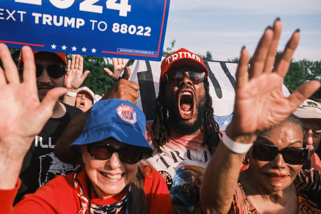 People attending a campaign rally for former US president Donald Trump in Cortona Park, Bronx, New York, holding signs; Christine Wenzel spotted among the crowd.