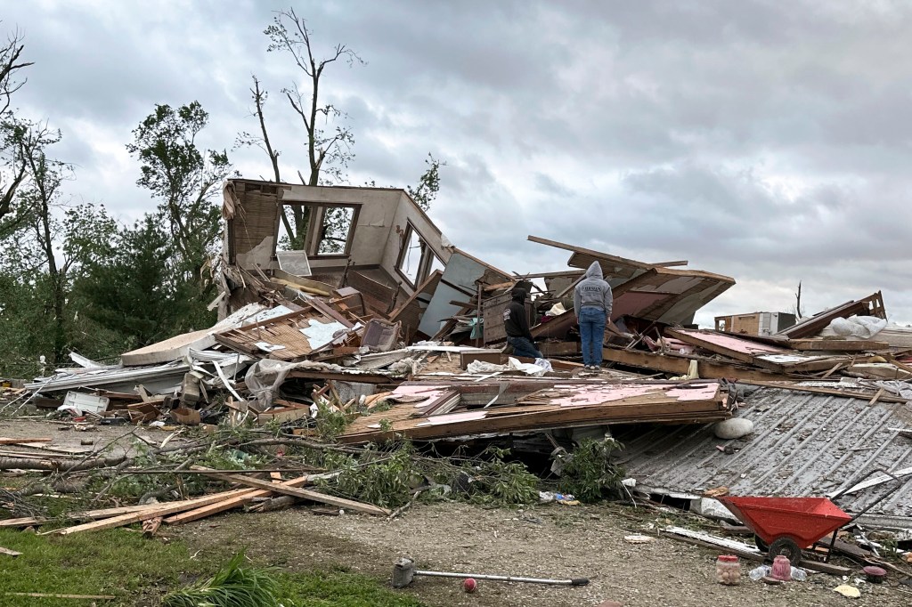 Parts of Greenfield appeared devastated. Mounds of broken wood, branches, car parts and other debris littered lots where homes once stood.