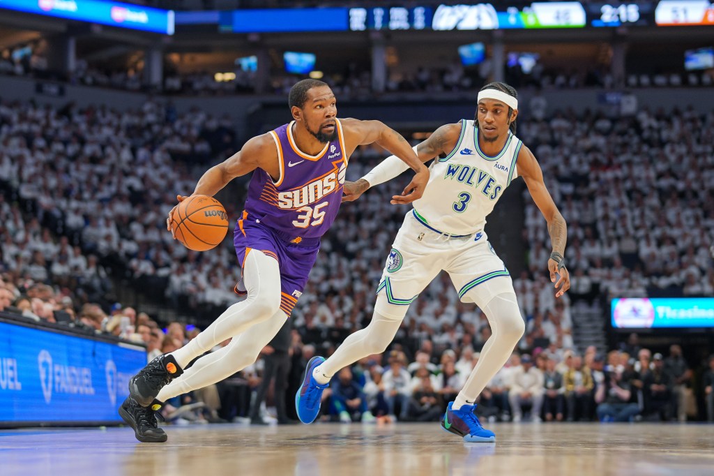 Suns forward Kevin Durant (35) dribbles against Minnesota Timberwolves forward Jaden McDaniels 