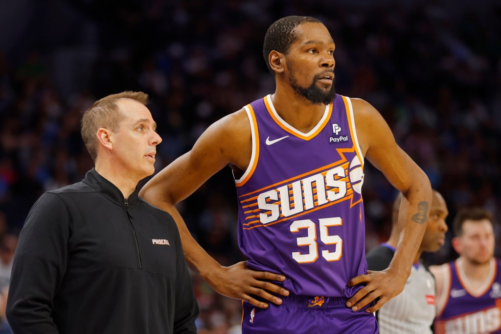 Phoenix Suns head coach Frank Vogel speaks with forward Kevin Durant (35) during a free throw  by the Minnesota Timberwolves in the third quarter at Target Center on April 14, 2024. 