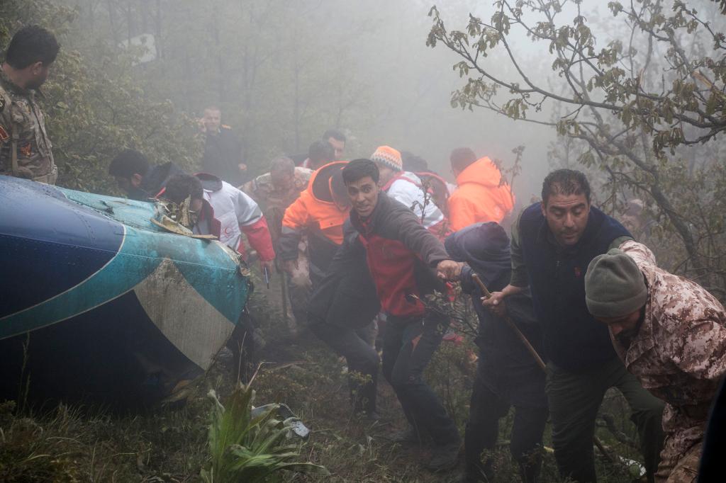 Rescue team members work at the scene of a crash of a helicopter carrying Iranian President Ebrahim Raisi in Varzaghan in northwestern Iran, Monday, May 20, 2024.