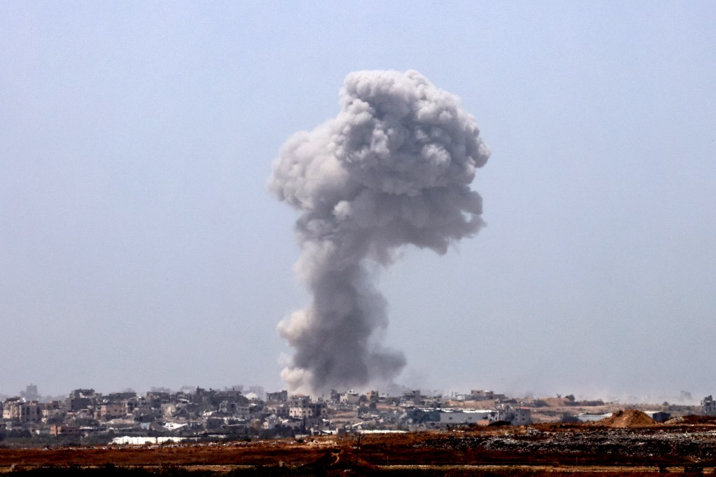 A smoke plume rises over the Gaza Strip following an Israeli bombardment on May 21, 2024.