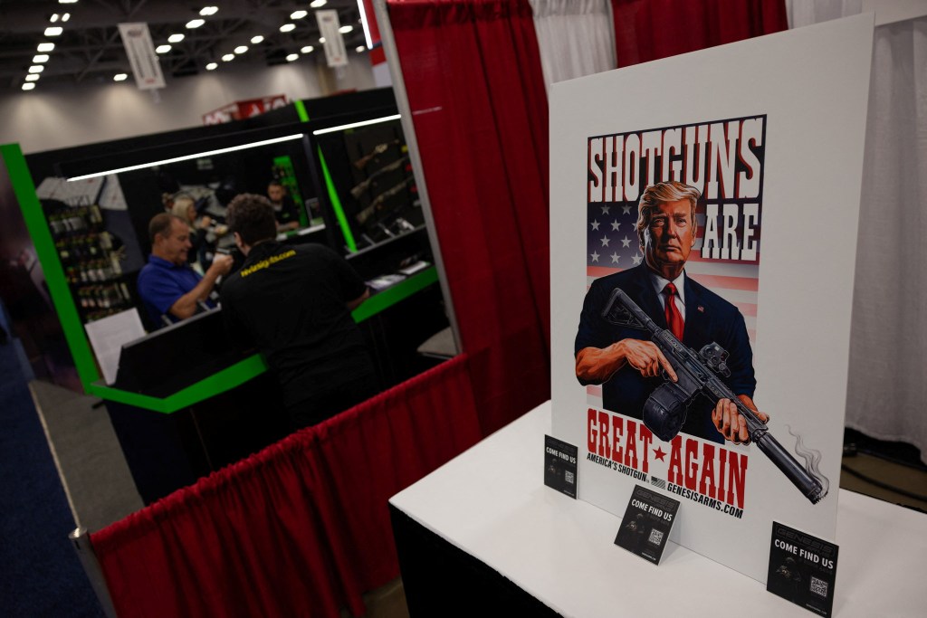 A poster depicting Republican presidential candidate and former U.S. President Donald Trump is displayed at an exhibition booth during the National Rifle Association (NRA) annual convention in Dallas, Texas, U.S., May 18, 2024