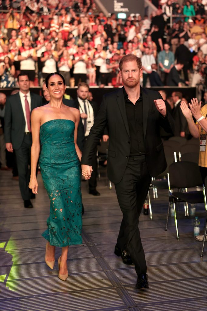 Prince Harry and Meghan, Duchess of Sussex, attending the closing ceremony of the Invictus Games Düsseldorf 2023, walking down a stage.