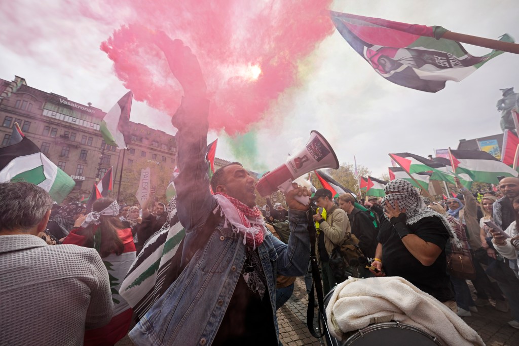 Protester shouting into a megaphone during a Pro-Palestinian demonstration against Israel's participation in Eurovision Song Contest in Malmo, Sweden.