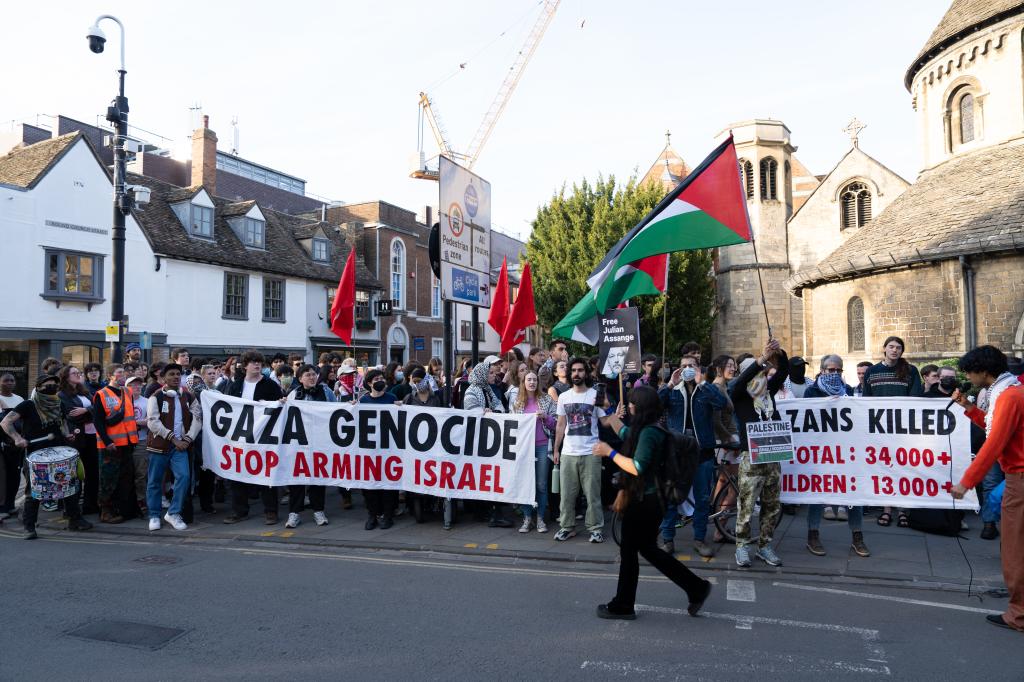 Protesters wave Palestinian flags outside the debate hall where Thiel appeared on Wednesday.