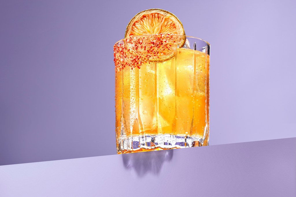 A glass of margarita with a slice of orange, photographed by Troy Studio for Mavericks Montauk.