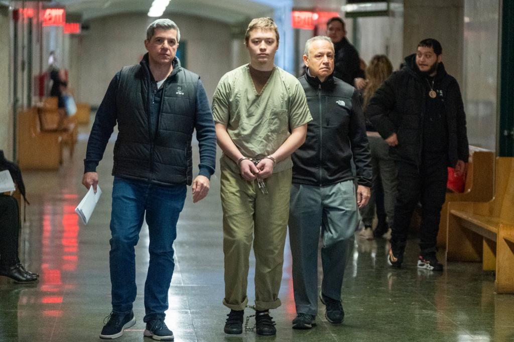 Trevor Bickford being walked in the courthouse hallway with handcuffs.