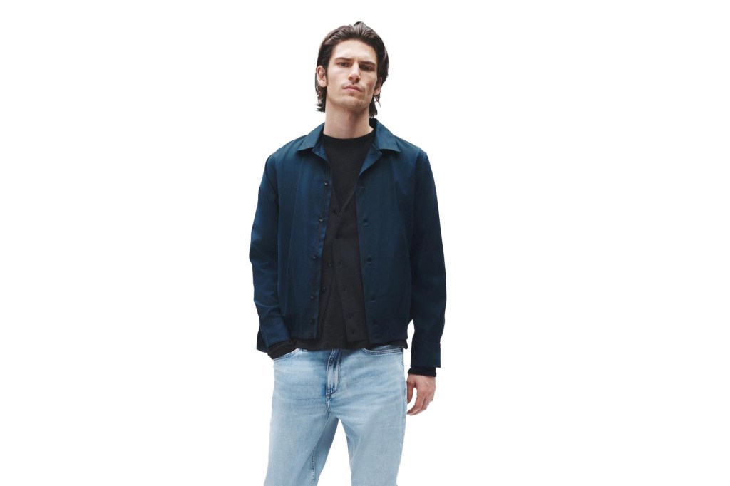 A man in a black shirt and blue jeans