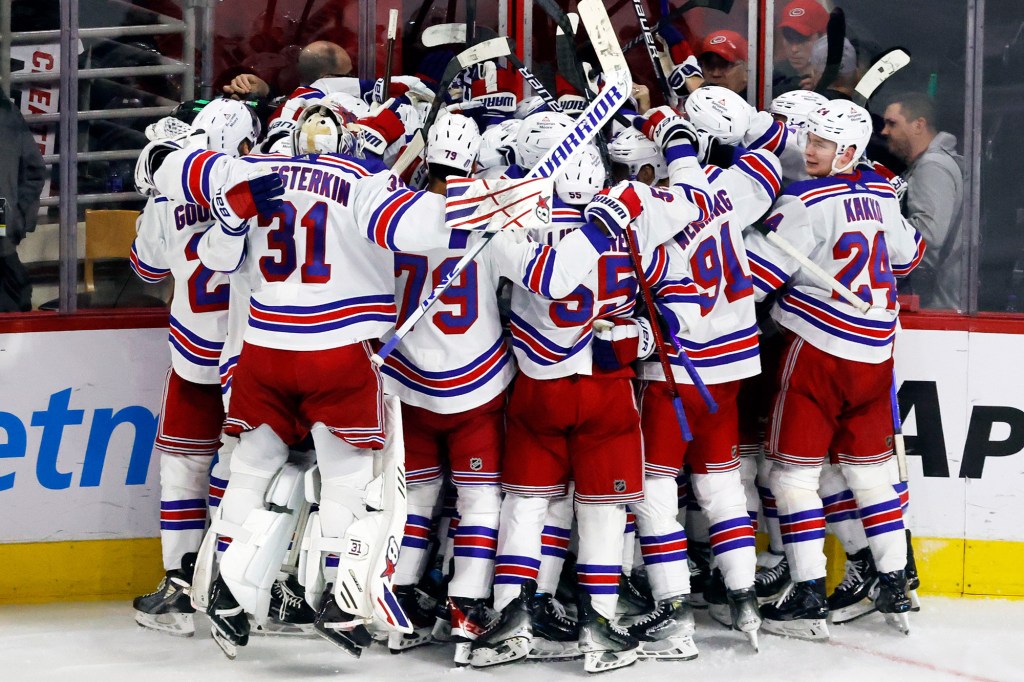 The Rangers celebrate after their Game 3 overtime victory Thursday against Carolina.