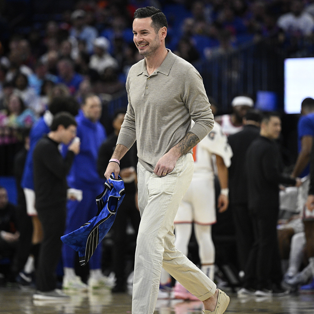 Former Orlando Magic guard JJ Redick, center, leaves the court after being honored by the team during the first half of an NBA basketball game against the New York Knicks, Wednesday, Feb. 14, 2024, in Orlando, Fla.  