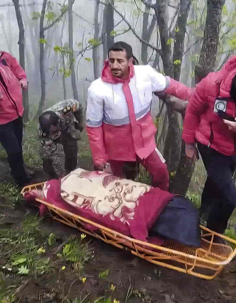 Rescue team members carry remains at the scene of a crash of a helicopter carrying Iranian President Ebrahim Raisi in Varzaghan in northwestern Iran, Monday, May 20, 2024.