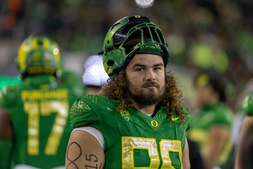 Defensive lineman Casey Rogers #98 of the Oregon Ducks stands on the sidelines during their game against the Oregon State Beavers at Autzen Stadium on November 24, 2023 in Eugene, Oregon. 