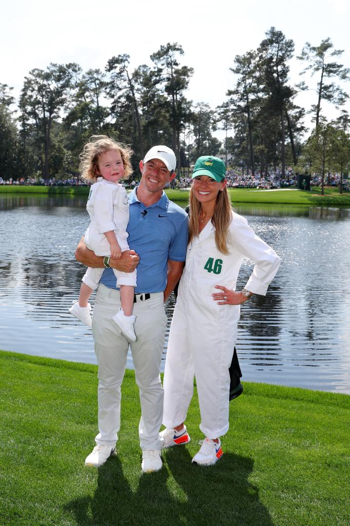 Rory McIlroy of Northern Ireland poses for a photo with his wife, Erica Stoll and daughter Poppy McIlroy during the Par 3 contest prior to the 2023 Masters Tournament at Augusta National Golf Club on April 5, 2023 in Augusta, Georgia.