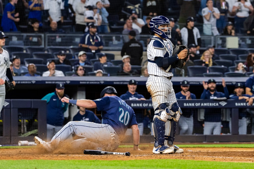 Mariners outfielder Luke Raley (20) scores on a SAC fly to tie the game during the ninth inning on Monday.
