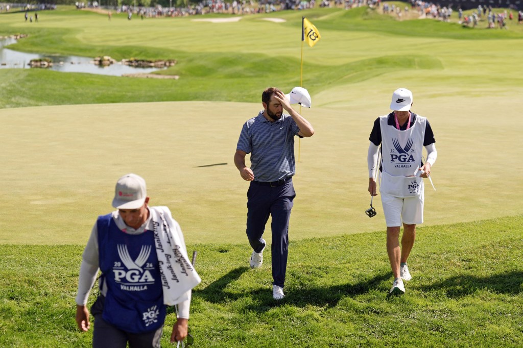 Scottie Scheffler and his caddie walk off the 18th green after the final round of the PGA Championship.