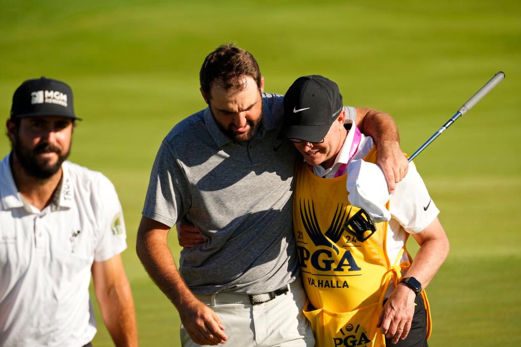 Scottie Scheffler embraces with his caddie on the 18th green after the third round of the PGA Championship on Saturday.