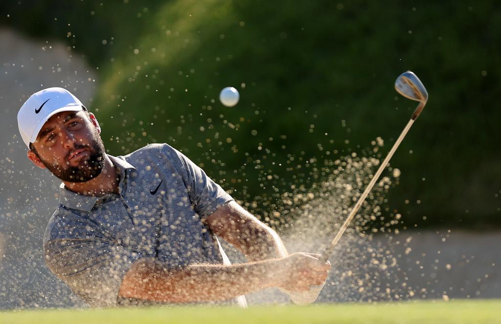 Scottie Scheffler of the United States plays a shot from a bunker on the 18th hole during the third round of the 2024 PGA Championship.