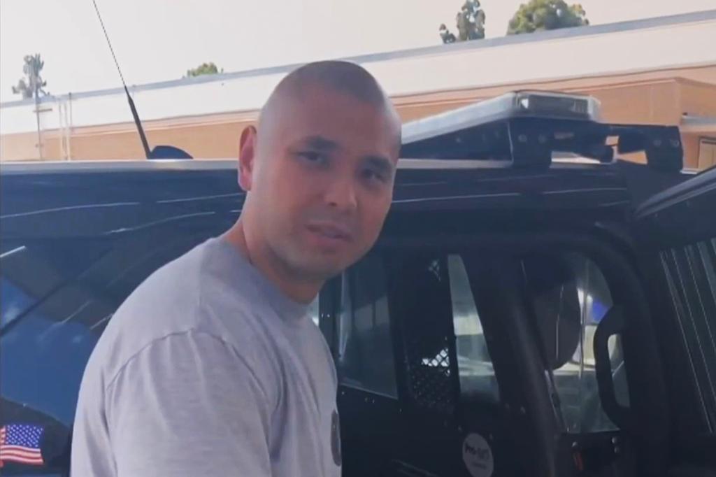 Officer Anthony Hair standing next to a patrol car, under investigation for procedural violations in August 2023 incident