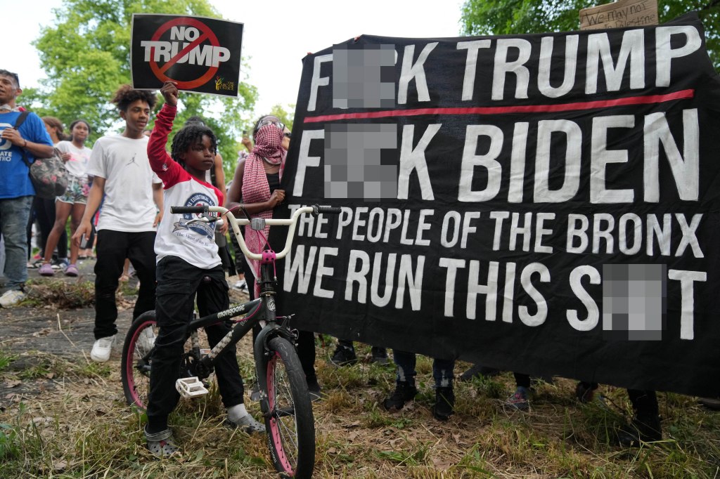 Protesters against former U.S. President and Republican presidential candidate Donald Trump hold a rally outside a campaign rally.