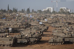 Israeli military vehicles gathered near the border fence with the Gaza Strip