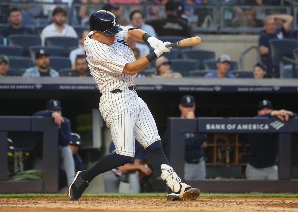 Yankees shortstop Anthony Volpe (11) singles during the third inning against the Seattle Mariners.