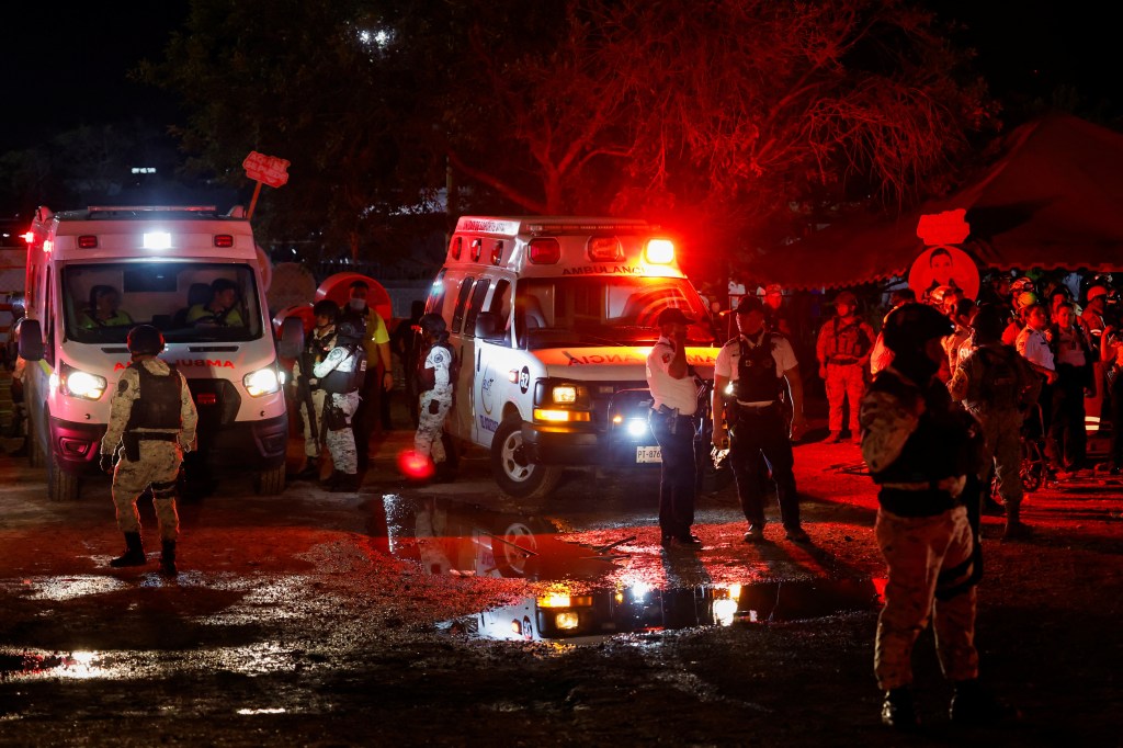 Soldiers stand near ambulances following the stage collapse on May 22, 2024.