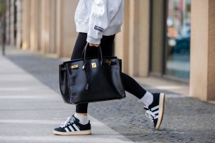 Sonia Lyson wearing black Adidas sneakers, Lululemon leggings, Worst Behavior hoodie and carrying a Hermes Birkin bag in Berlin, Germany, May 2024