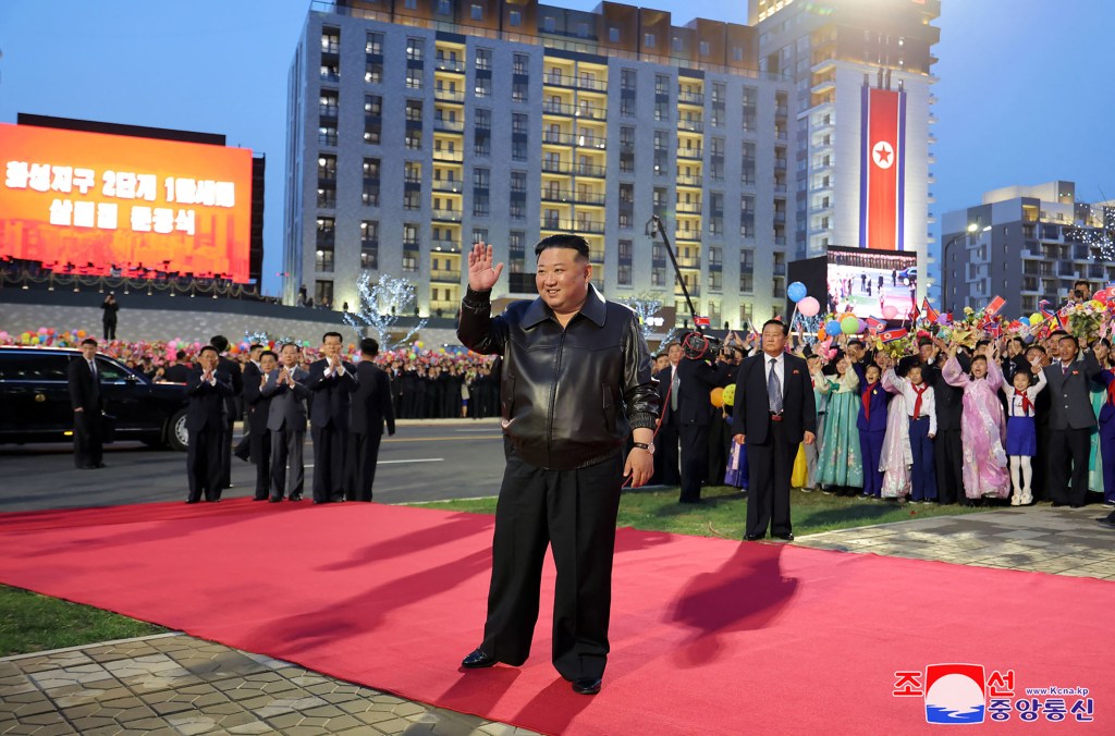Kim Jong Un waves on red carpet at event