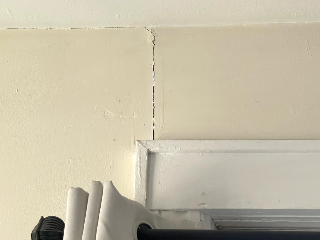 deep crack seen going from doorframe up to ceiling