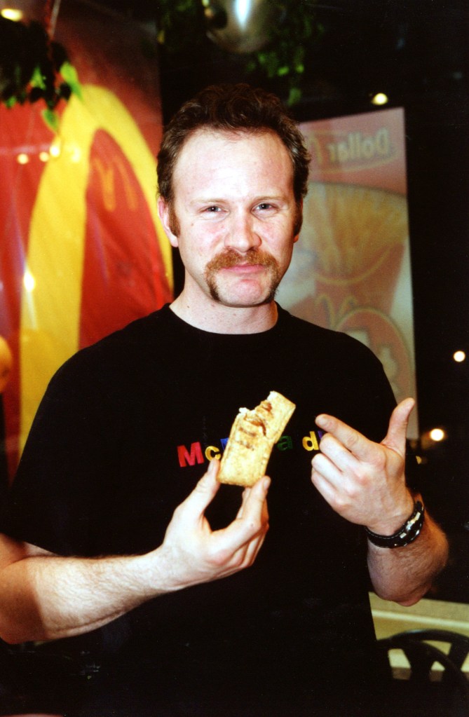 Morgan Spurlock holding a McDonald's hand pie