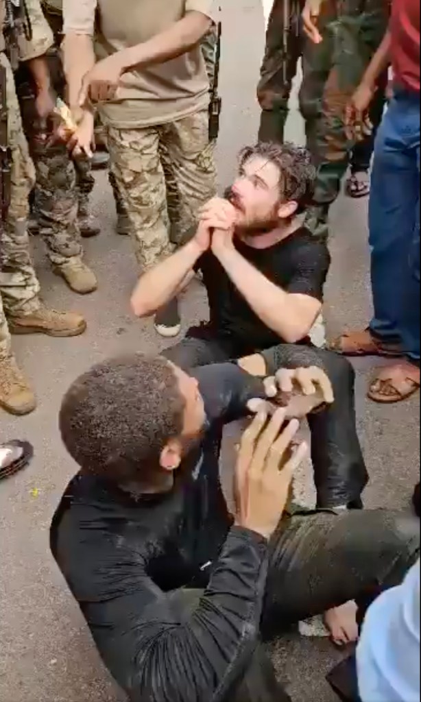 An American man is seen surrounded by soldiers after allegedly taking part in a failed coup in the Democratic Republic of Congo.