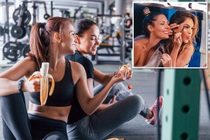 Two female friends in sportive clothes eating fruits during a break at the gym
