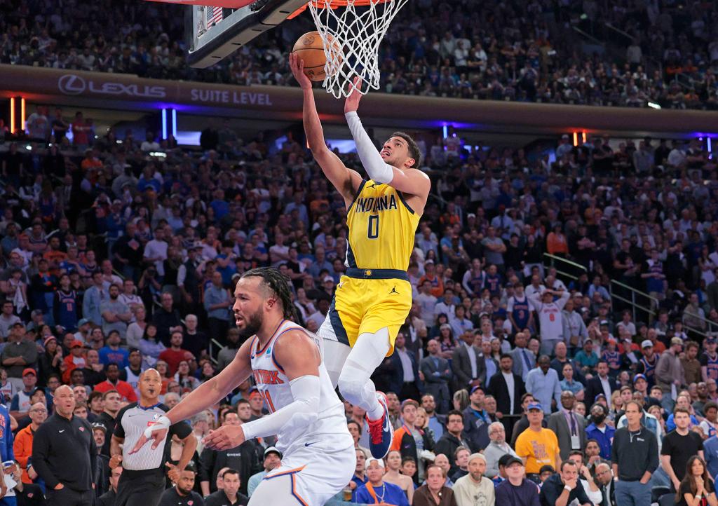 Indiana Pacers guard Tyrese Haliburton #0 goes up for a shot over New York Knicks guard Jalen Brunson #11 during the third quarter.