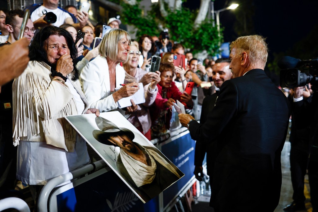 Kevin Costner interacts with fans at the Cannes Film Festival