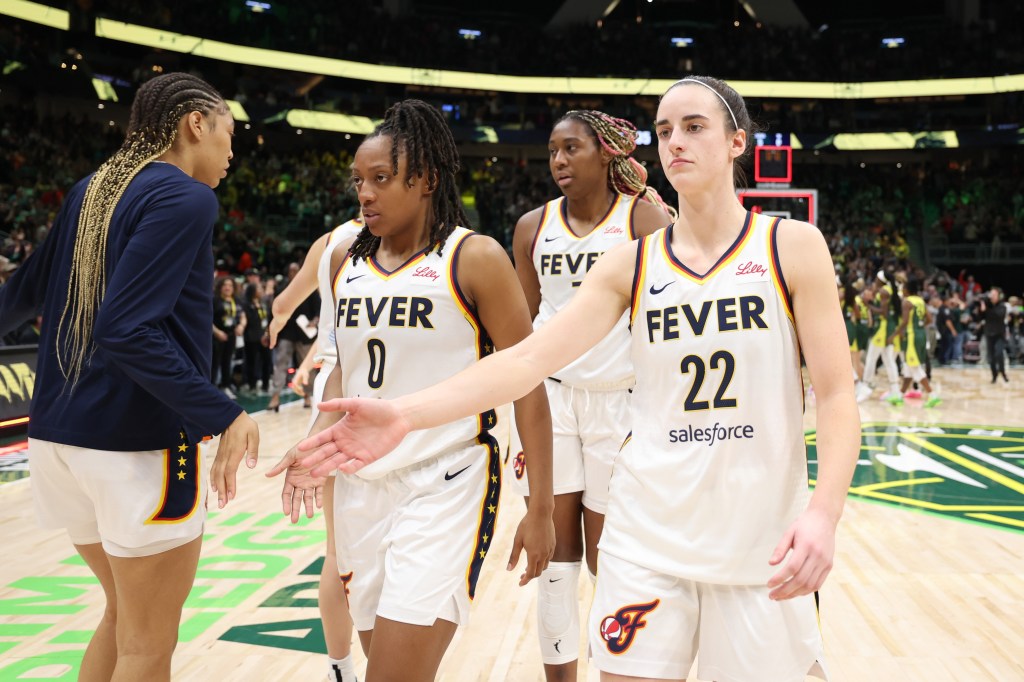 Caitlin Clark #22 of the Indiana Fever shakes hands with teammates after losing to the Seattle Storm  85-83 in the gme at Climate Pledge Arena on May 22, 2024 in Seattle, Washington.  